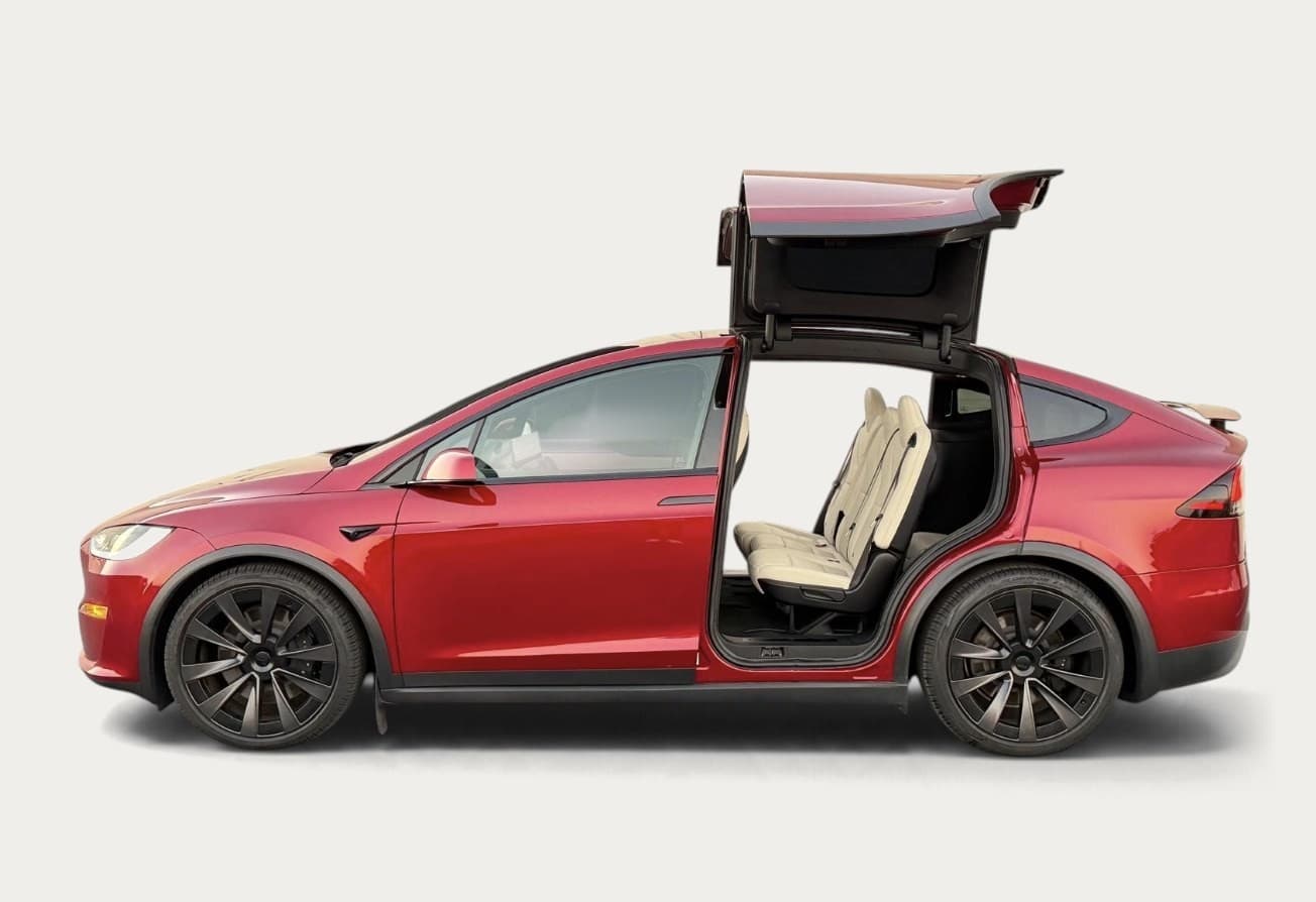 Red Tesla Model X with its rear doors open